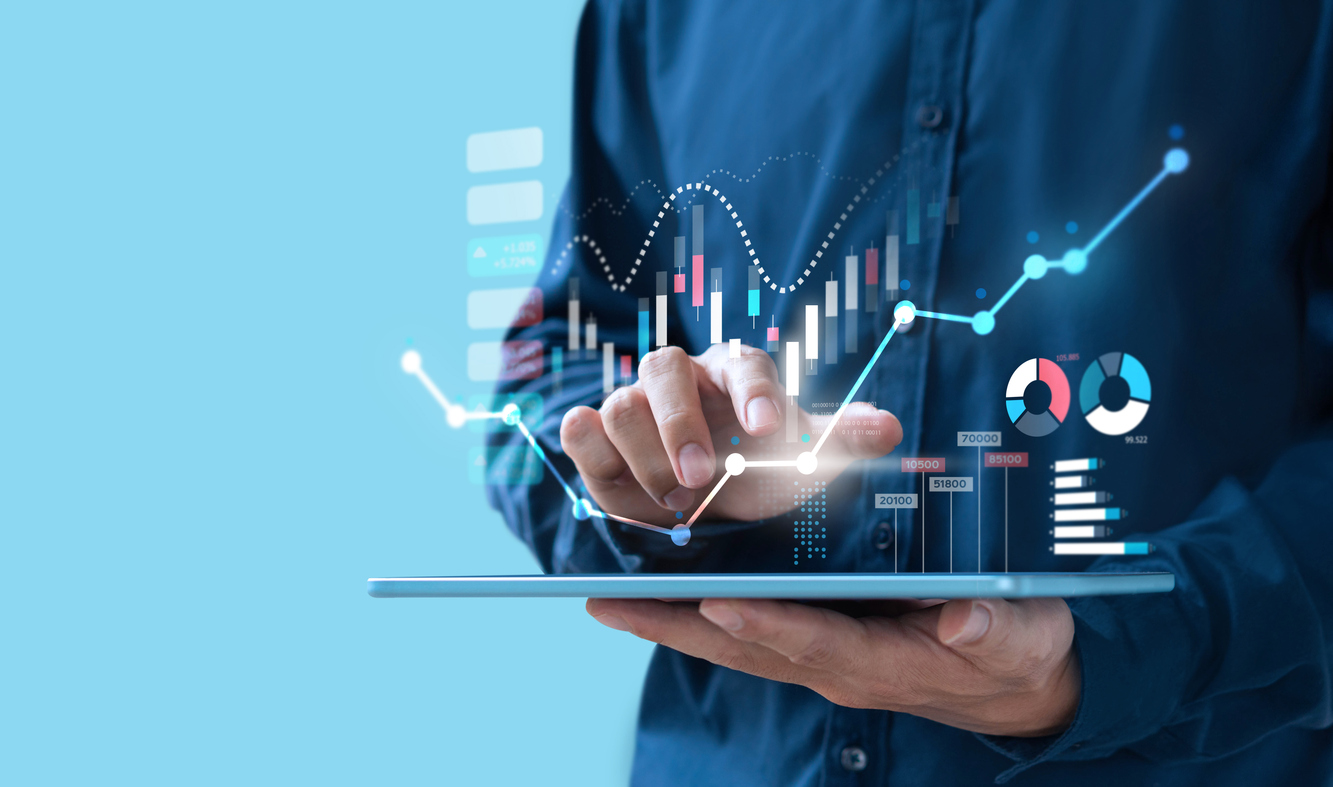 Person using tablet with glowing financial charts and graphs displaying data analytics.